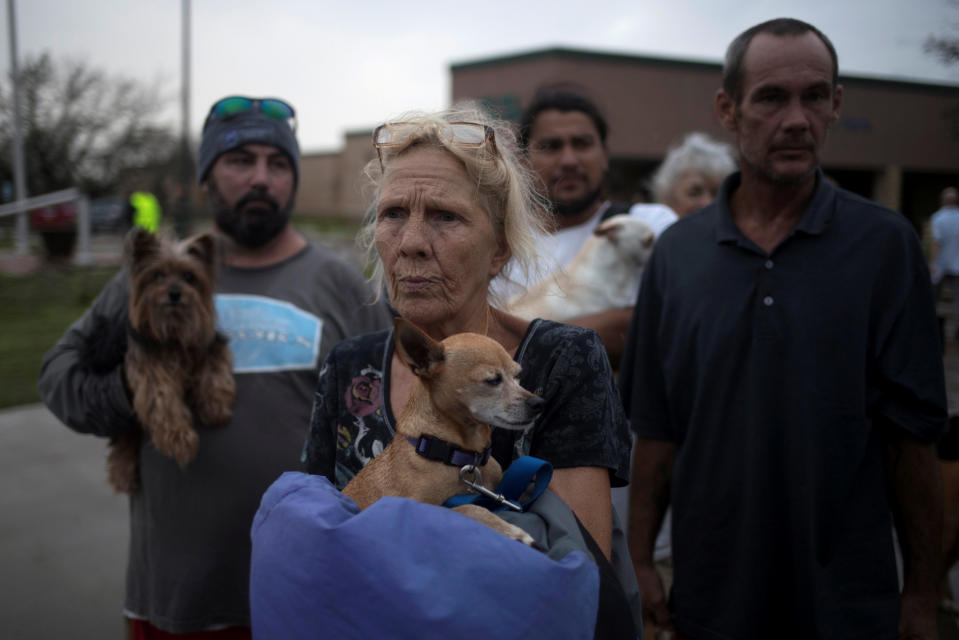 Julie holds her dog, Pee-wee, as they wait to be evacuated to Austin after losing their home to Hurricane Harvey in Rockport, Texas, Aug. 26, 2017. Adrees Latif/Reuters
