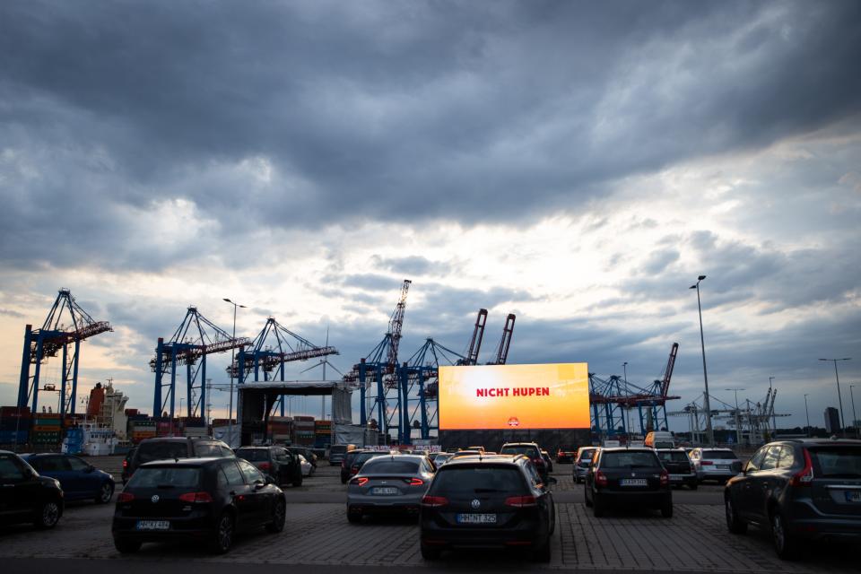 03 June 2020, Hamburg: Cars can be found at the drive-in cinema and car concert area "Cruise Inn" at the cruise ship terminal in Hamburg-Steinwerder. With the first presentation the drive-in cinema season in the Hanseatic city was rung in. In front of the 220 square meter screen there will be room for up to 620 cars. Photo: Christian Charisius/dpa (Photo by Christian Charisius/picture alliance via Getty Images)