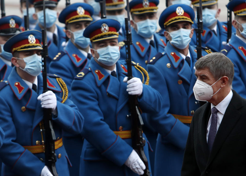 Czech Prime Minister Andrej Babis, right, reviews the honor guard during a welcome ceremony ahead of meeting with his Serbian counterpart Ana Brnabic at the Serbia Palace in Belgrade, Serbia, Wednesday, Feb. 10, 2021. Babis is on a one-day official visit to Serbia. (AP Photo/Darko Vojinovic)