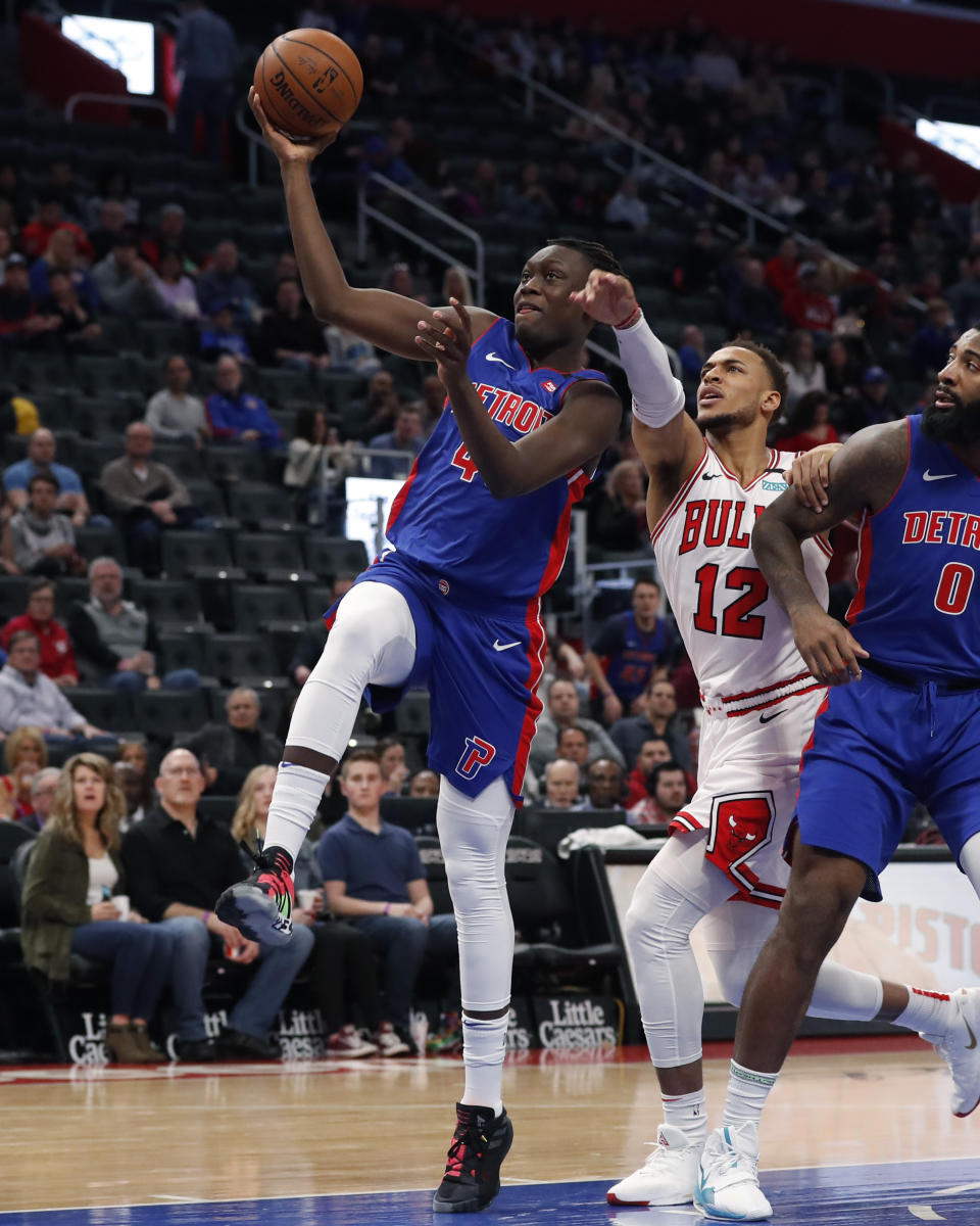 Detroit Pistons forward Sekou Doumbouya (45) makes a layup as Chicago Bulls forward Daniel Gafford (12) reaches in during the first half of an NBA basketball game, Saturday, Jan. 11, 2020, in Detroit. (AP Photo/Carlos Osorio)