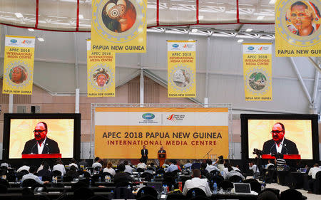 Papua New Guinea Prime Minister Peter O'Neill speaks as the Asia Pacific Economic Cooperation (APEC) Chief Executive Officer, Chris Hawkins listens during a media conference at the end of the APEC forum in Port Moresby, Papua New Guinea, November 18, 2018. REUTERS/David Gray