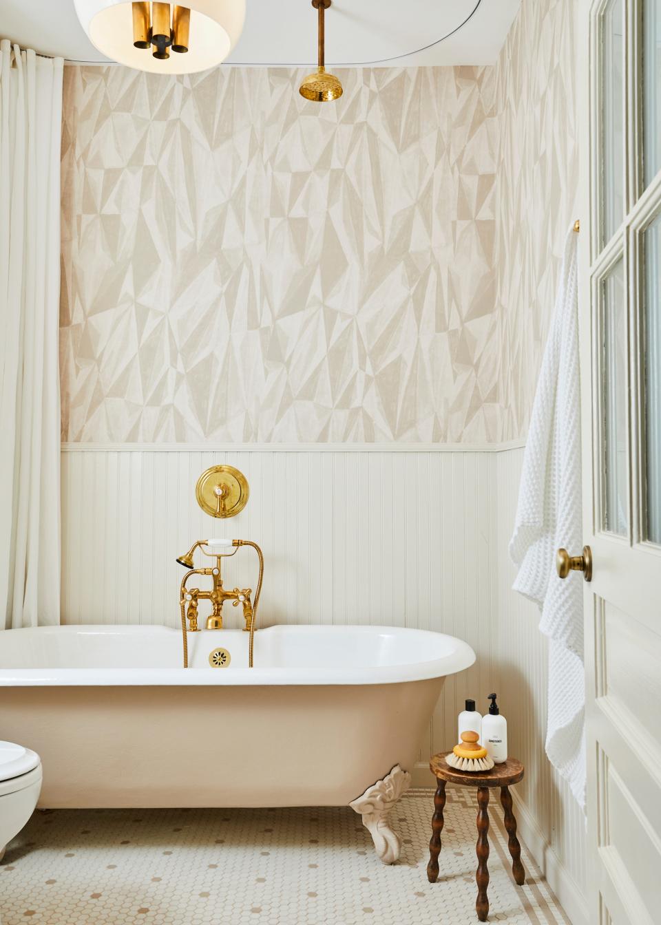 “I love to work with classic or traditional elements but make a slight twist so it becomes more modern,” says Sherman Samuel of the ’20s-inspired custom tile floor in the guest bathroom in New York: The light tonal, monochromatic theme “makes it fresh.” Geometric wallpaper and a vintage fixture the designer found in a Michigan antique store spoke to Carlton’s desire for balancing the new with something old.