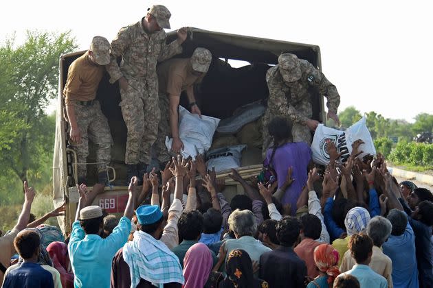 Army soldiers distribute relief food bags to flood affected people in Shikarpur of Sindh province on Aug. 28, 2022. (Photo: ASIF HASSAN/AFP/Getty Images)