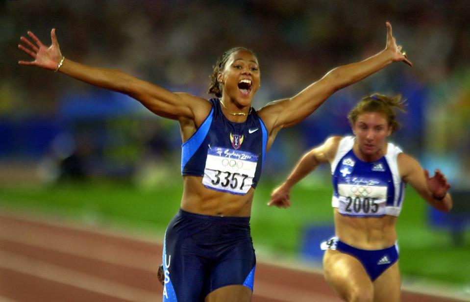 Marion Jones crosses the finish line to win her first Olympic gold in Sydney.