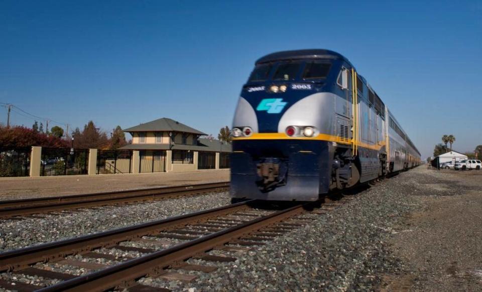 An Amtrak Capitol Corridor passenger train speeds past the downtown Dixon train depot in 2014.