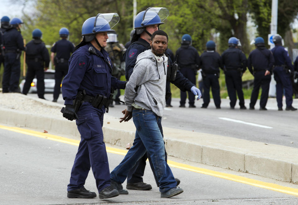 Baltimore police officers detain a demonstrator after the funeral of Freddie Gray, Monday, April 27, 2015, in Baltimore. (AP Photo/Jose Luis Magana)