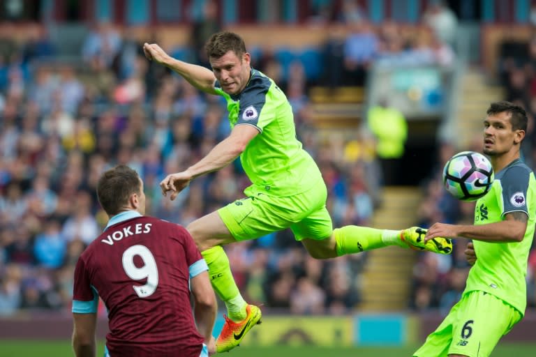 Liverpool's James Milner (C) wins a header as Burnley's Sam Vokes (L) and Liverpool's Dejan Lovren look on during their English Premier League match at Turf Moor in Burnley on August 20, 2016