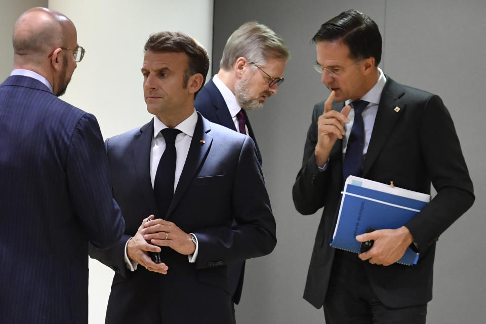 French President Emmanuel Macron, second left, speaks with European Council President Charles Michel, left, as Netherland's Prime Minister Mark Rutte, right, speaks with Czech Republic's Prime Minister Petr Fiala during a round table meeting at an EU summit in Brussels, Friday, Oct. 21, 2022. European Union leaders are gathering Friday to take stock of their support for Ukraine after President Volodymyr Zelenskyy warned that Russia is trying to spark a refugee exodus by destroying his war-ravaged country's energy infrastructure. (AP Photo/Geert Vanden Wijngaert)