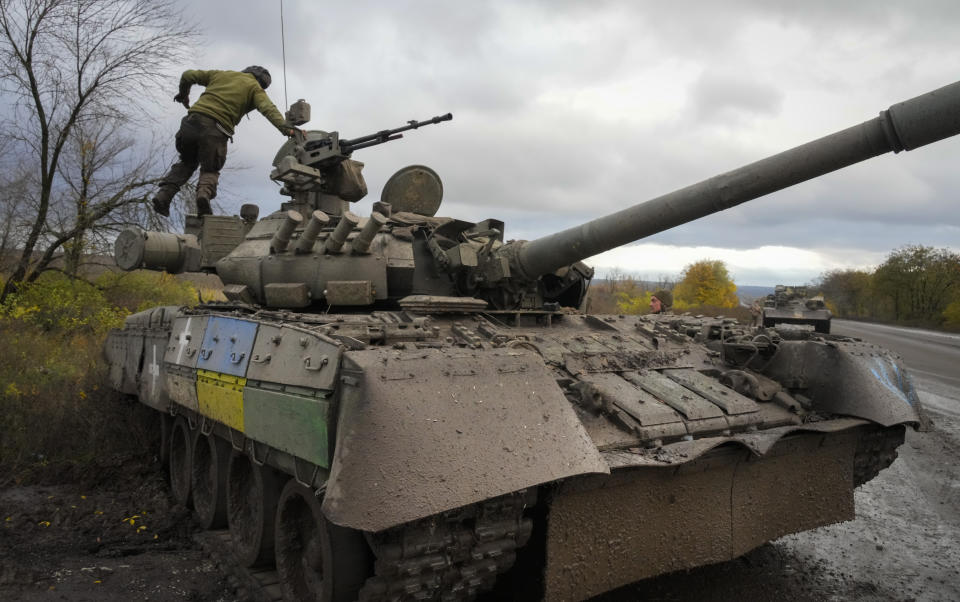 Ukrainian soldiers work with a captured Russian tank T-80 on the road to Bakhmut, the site of the heaviest battle against the Russian troops in the Donetsk region, Ukraine, Thursday, Oct. 27, 2022. (AP Photo/Efrem Lukatsky)