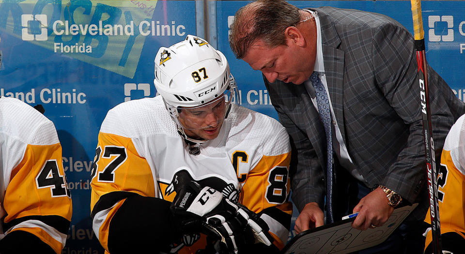 SUNRISE, FL - FEBRUARY 8: A fan has a message for Sidney Crosby #87 of the Pittsburgh Penguins while he chats with Assistant Coach Mark Recchi during a break in the action against the Florida Panthers at the BB&T Center on February 8, 2020 in Sunrise, Florida. (Photo by Eliot J. Schechter/NHLI via Getty Images) 