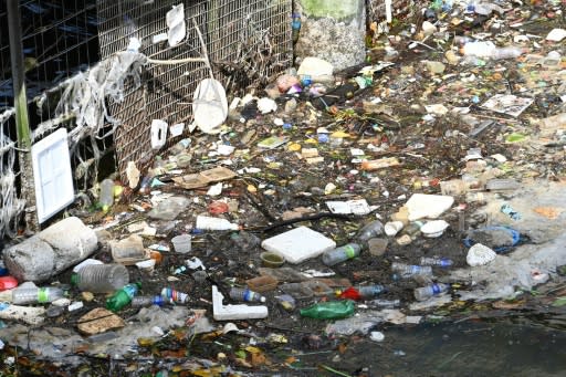 Bottles, styrofoam and other plastic waste thrown into the sea float by a pier in Singapore