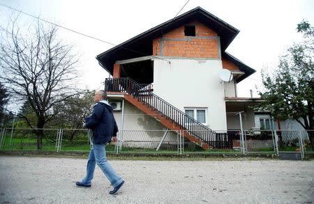 A man passes by the family residence of British aid worker David Haines in Sisak, central Croatia, September 14, 2014. REUTERS/Antonio Bronic