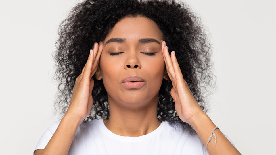 A woman exhaling to help restore her nervous system regulation