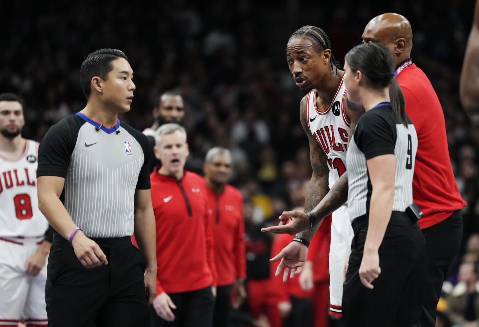 Chicago Bulls' DeMar DeRozan (11) argues with referee Evan Scott, left, during the first half of the team's NBA basketball In-Season Tournament game against the Toronto Raptors on Friday, Nov. 24, 2023, in Toronto. (Frank Gunn/The Canadian Press via AP)