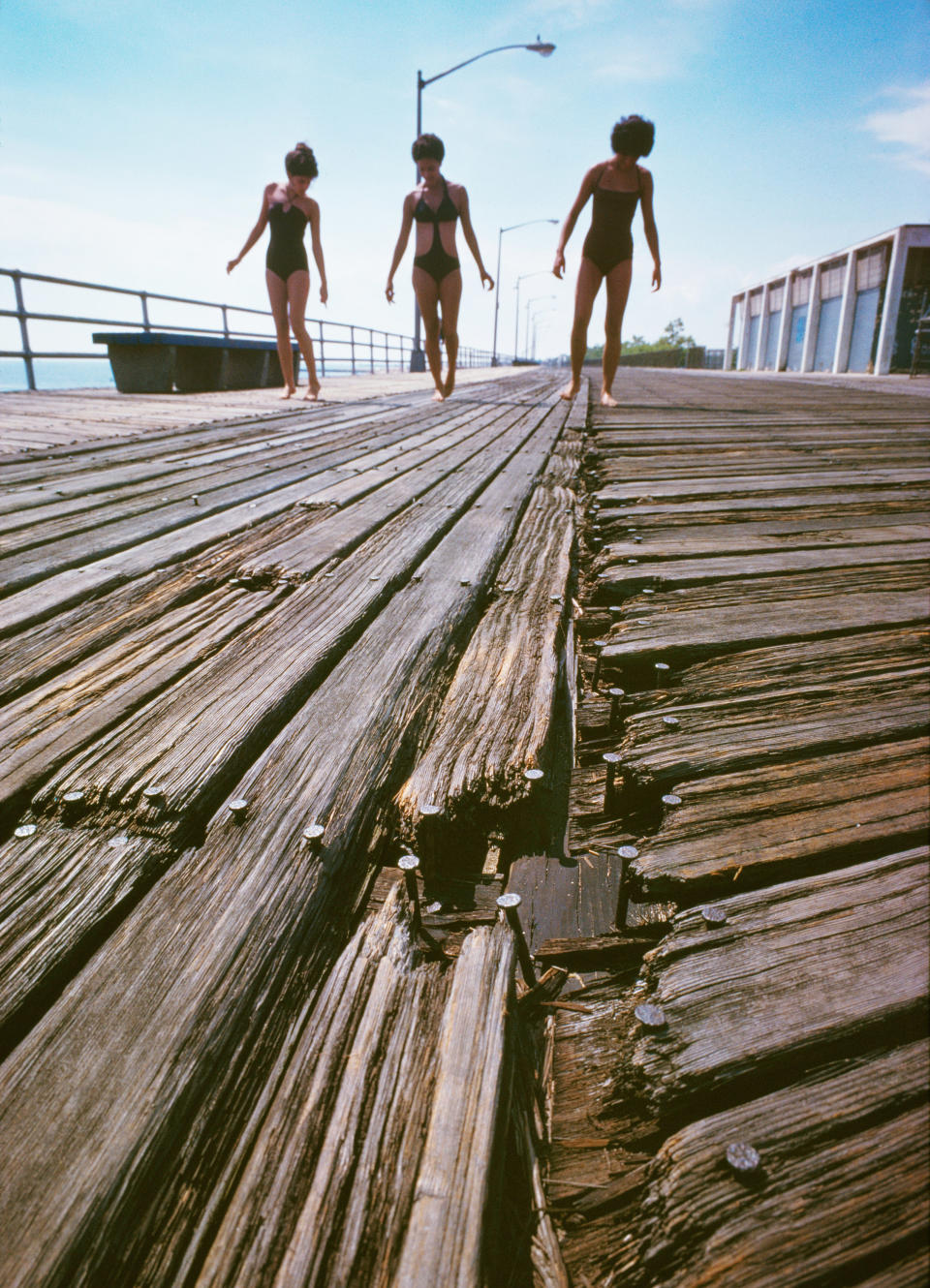 <p>Girls on splintered boardwalk, South Beach, Staten Island. (Photograph by Neal Boenzi/NYC Parks Photo Archive/Caters News) </p>