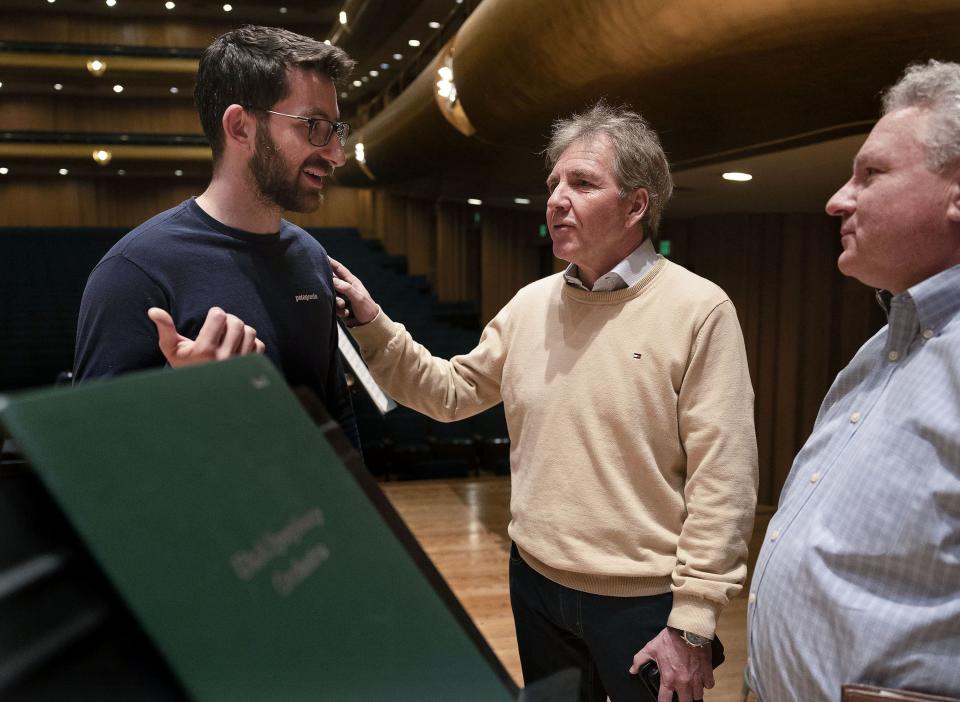 Thierry Fischer, the music director of the Utah Symphony, center, speaks with assistant conductor Ben Manis, left, and David Green, Senior Vice President & COO of the Utah Symphony, before rehearsal at Abravanel Hall in Salt Lake City on Thursday, May 25, 2023. Fischer concludes his 14 years with the symphony this weekend. | Laura Seitz, Deseret News
