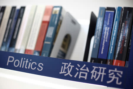 Books on politics are seen on a shelf at the Cambridge University Press (CUP) stall at the Beijing International Book Fair in Beijing, China, August 23, 2017. REUTERS/Thomas Peter