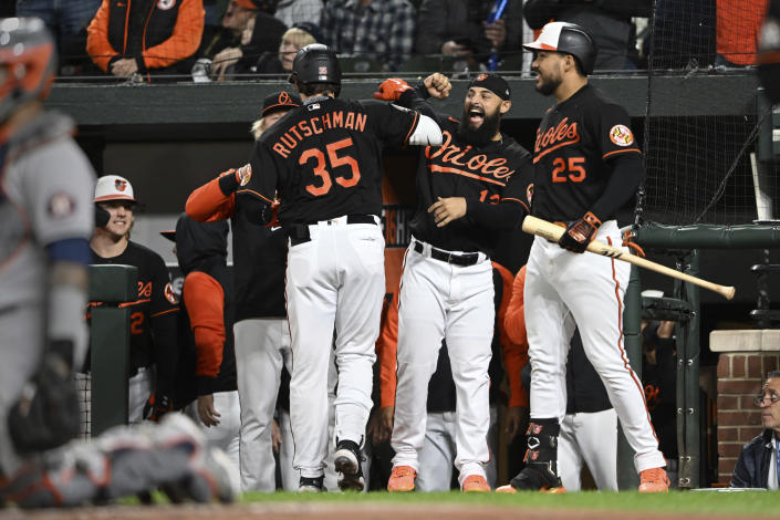 Baltimore Orioles' Adley Rutschman, left, is congratulated by Rougned Odor after hitting a solo home run against the Houston Astros during the fourth inning of a baseball game Friday, Sept. 23, 2022, in Baltimore. (AP Photo/Gail Burton)