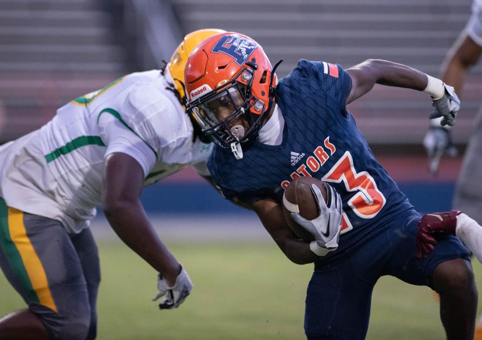 Diego Dukes (13) carries the ball during the Pensacola Catholic vs Escambia football game at Escambia High School in Pensacola on Friday, Sept. 1, 2023.