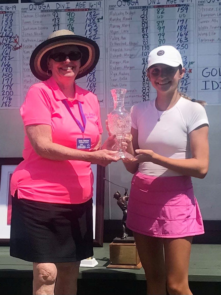 Marion's Diana Morgan presents the Kay Wigton champions trophy to the 2022 Ohio Junior Girls Championship winner Sydney Deal of Perrysburg Tuesday at Marion Country Club.