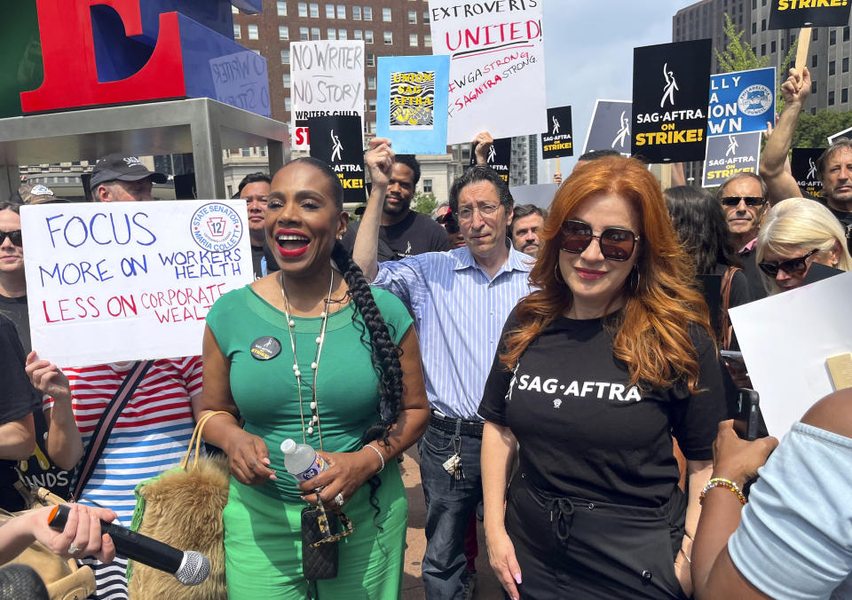 Actors Sheryl Lee Ralph, left, and Lisa Ann Walter, members of the cast of "Abbott Elementary," participate in a rally in support of the actors and writers strikes at Love Park in Philadelphia on Thursday, July 20, 2023. The actors strike comes more than two months after screenwriters began striking in their bid to get better pay and working conditions. (AP Photo/Tassanee Vejpongsa)