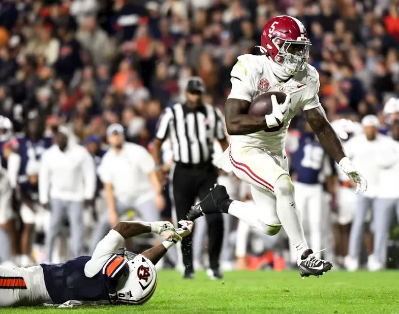 More 'Bama ballet, as Roydell Williams leaps past an Auburn defender, in the Nov. 25, 2023 Iron Bowl. The Crimson Tide overcame numerous mistakes and a few questionable calls, to take the lead on a Hail Mary from fourth and 31.