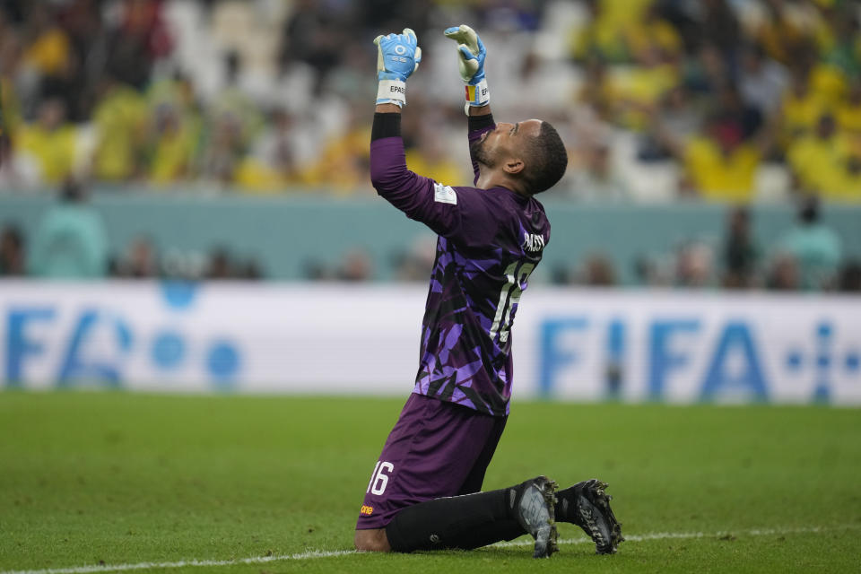 Cameroon's goalkeeper Devis Epassy celebrates at the end of the World Cup group G soccer match between Cameroon and Brazil, at the Lusail Stadium in Lusail, Qatar, Friday, Dec. 2, 2022. (AP Photo/Natacha Pisarenko)