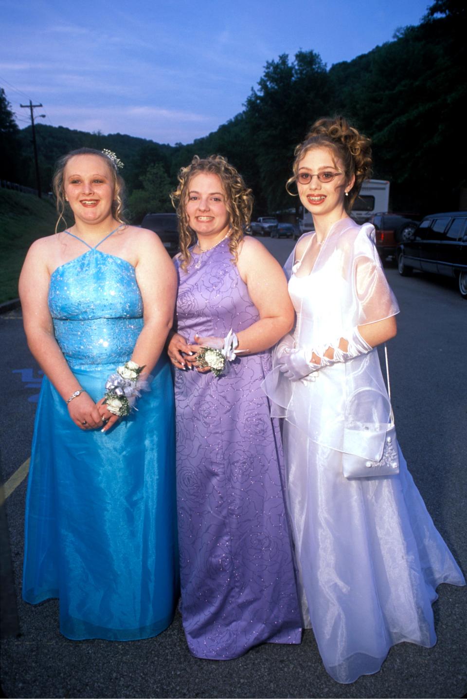 Three girls wearing prom dresses in 2002