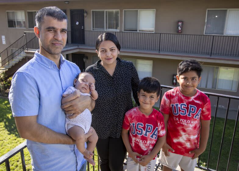 San Diego, CA - September 22: Hamid and Masooda Qazi, shown with their kids Dewa, 2 months old, Hasib, 6, and Habib, 10, at their San Diego apartment. Hamid and Masooda worked as attorneys in their native Afghanistan, with successful careers working for the Afghan and U.S. governments, before the fall of Kabul, when they were forced to flee with their two young sons for their safety. They have since immigrated to San Diego, had a baby girl, and are both looking to re-enter the legal field with some help from local attorneys and judges. Photo taken in San Diego Thursday, Sept. 22, 2022. (Allen J. Schaben / Los Angeles Times)