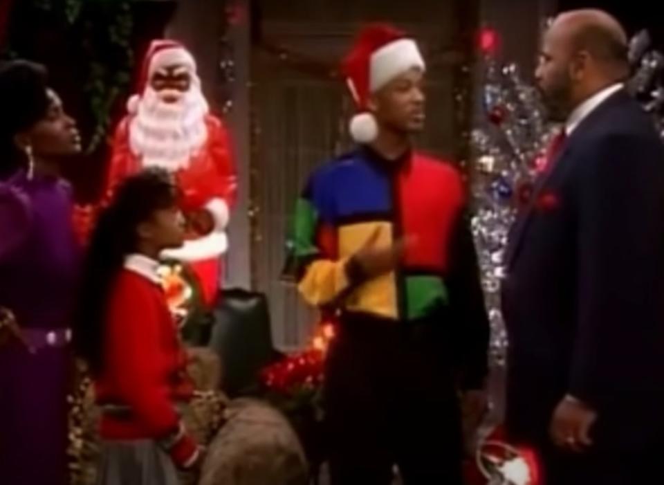 Vivian, Ashley, Will, and Uncle Phil talk in their festive family room in "The Fresh Prince of Bel-Air"