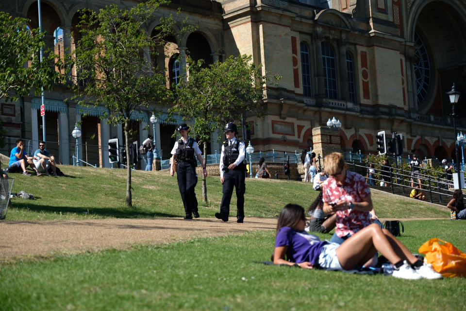 Police officers patrol as people enjoy the weather at Alexandra Palace, London, after the introduction of measures to bring the country out of lockdown. (Photo by Ian Hinchliffe/PA Images via Getty Images)