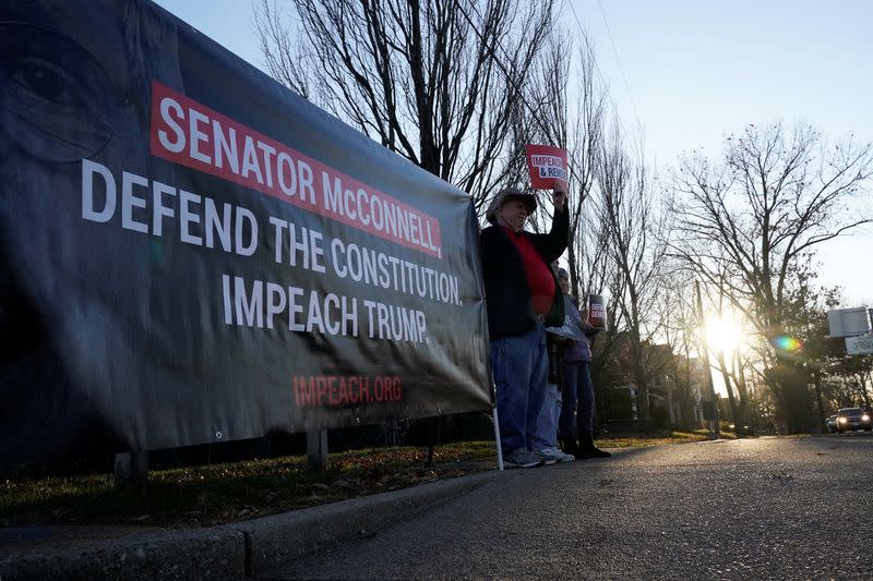 Protesters gather near the home of U.S. Senator Mitch McConnell in support of the impeachment of U.S. President Donald Trump, in Louisville, Kentucky