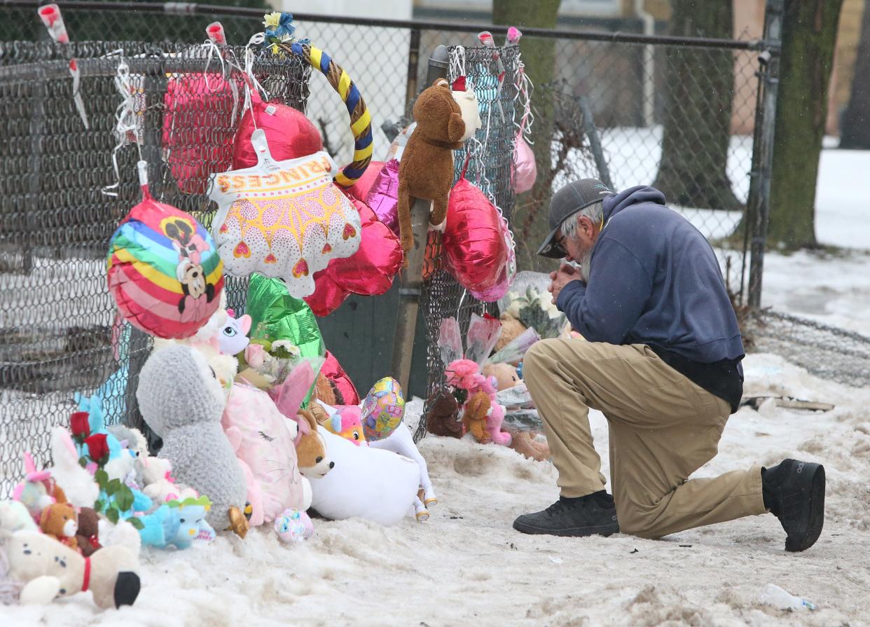 Mark Osborne kneels and prays outside the house at 222 N. LaPorte Ave. on Wednesday, Jan. 24, 2024, after Sunday’s fire where five children died inside the home. A sixth child, Angel Smith, 11, died from her injuries Friday, Jan. 26 at Riley Children's Health in Indianapolis. Osborne, who said he lives nearby, said this was his second time he stopped by to say a prayer for the victims.