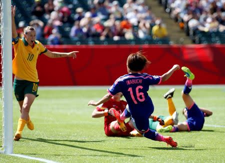 Jun 27, 2015; Edmonton, Alberta, CAN; Japan forward Mana Iwabuchi (16) scores as Australia midfielder Emily Van Egmond (10) defends during the second half in the quarterfinals of the FIFA 2015 Women's World Cup at Commonwealth Stadium. Mandatory Credit: Erich Schlegel-USA TODAY Sports