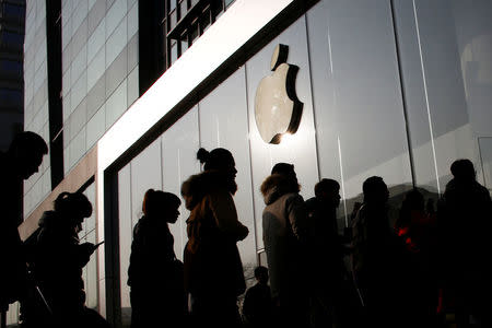 People line up at an Apple store shortly before it opens in Beijing, China, January 3, 2017. REUTERS/Thomas Peter