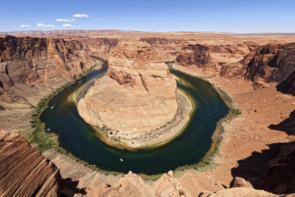 FILE - The Colorado River flows at Horseshoe Bend in Glen Canyon National Recreation Area, Wednesday, June 8, 2022, in Page, Ariz. In Arizona, water officials are concerned, though not panicking, about getting water in the future from the Colorado River as its levels decline and the federal government talks about the need for states in the Colorado River Basin to reduce use. (AP Photo/Brittany Peterson, File)