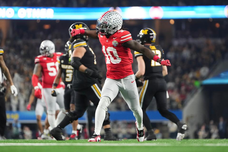 Dec 29, 2023; Arlington, Texas, USA; Ohio State Buckeyes cornerback Denzel Burke (10) celebrates a tackle during the first quarter of the Goodyear Cotton Bowl Classic against the Missouri Tigers at AT&T Stadium.