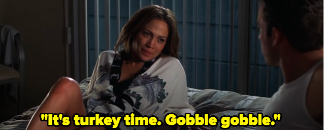 A woman lying on a bed saying, "It's turkey time. Gobble gobble."