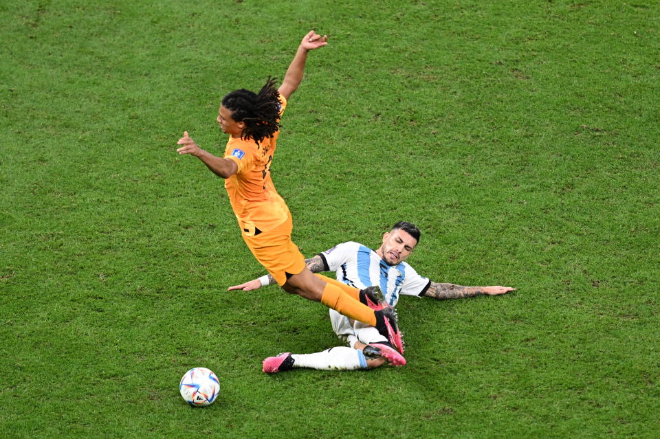 LUSAIL CITY, QATAR - DECEMBER 09: Nathan Ake #5 of Netherlands in action against Leandro Paredes #5 of Argentina during the FIFA World Cup Qatar 2022 quarter final match between Netherlands and Argentina at Lusail Stadium on December 9, 2022 in Lusail City, Qatar. (Photo by Evrim Aydin/Anadolu Agency via Getty Images)