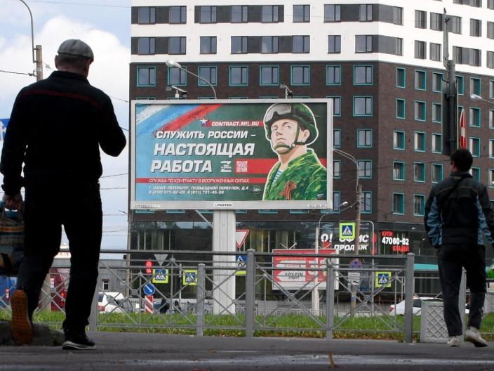 A billboard promoting contract army service with an image of a serviceman and the slogan reading &quot;Serving Russia is a real job&quot; sits in Saint Petersburg on September 20, 2022.