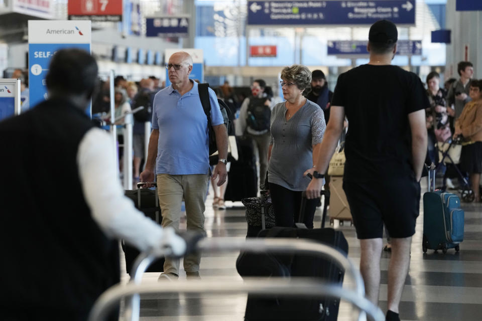 Travelers walk through Terminal 3 at O'Hare International Airport in Chicago, Thursday, Aug. 31, 2023. The Federal Aviation Administration predicts that this will be the third busiest holiday weekend of the year so far, behind only the Juneteenth weekend, which included Father's Day, and the Presidents Day break.(AP Photo/Nam Y. Huh)