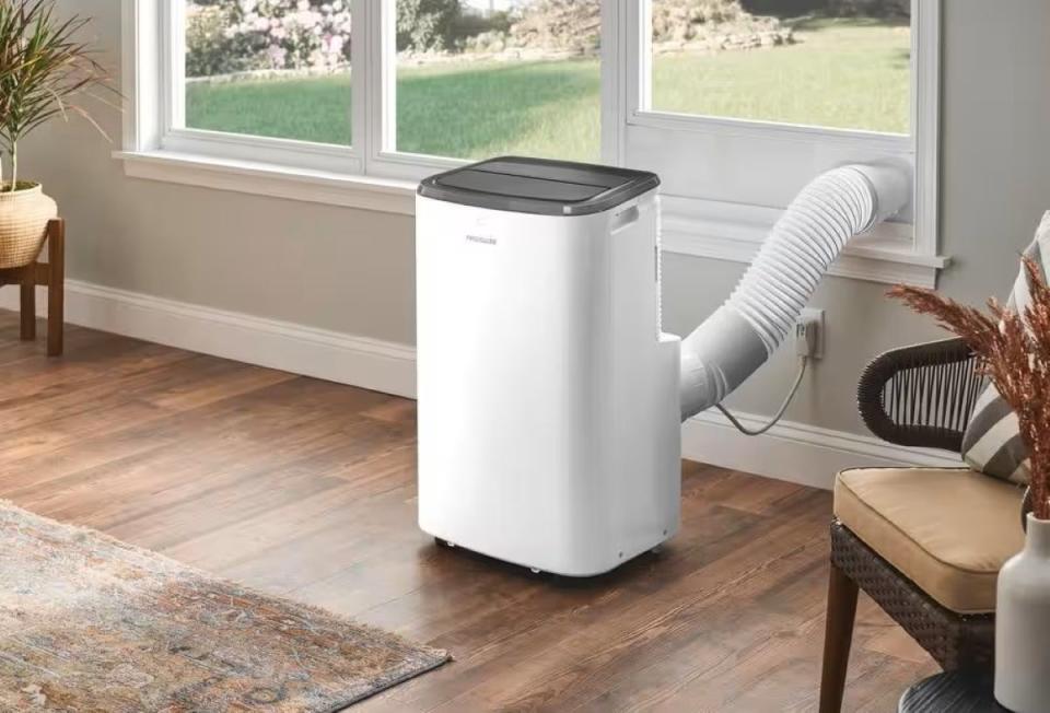 White portable air conditioner with vent to window