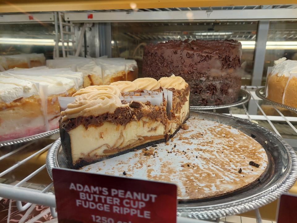 A photo of the Adam's Peanut Butter Cup Fudge Ripple Cheesecake in a fridge at the Cheesecake Factory