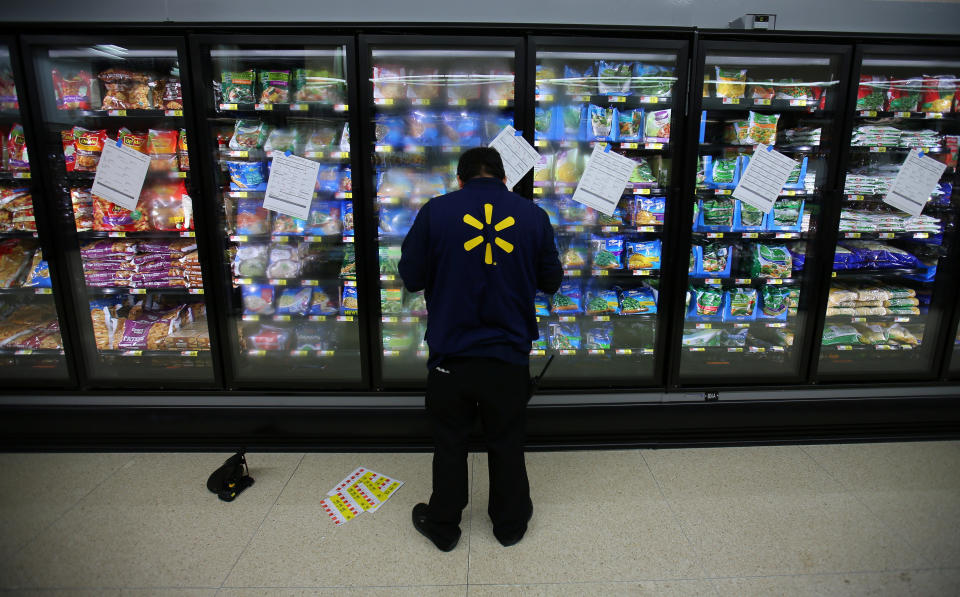 A worker prepares the frozen food section at a newly built Walmart Super Center prior to its opening in Compton, California, U.S., January 10, 2017.  REUTERS/Mike Blake