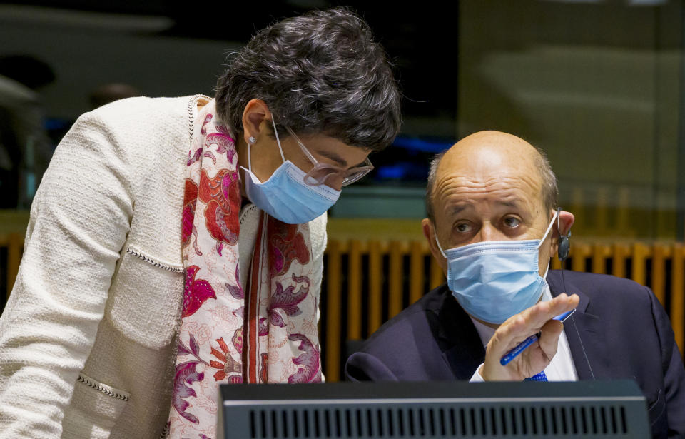 French Foreign Minister Jean-Yves Le Drian, right, speaks with Spain's Foreign Minister Arancha Gonzalez Laya during a meeting of European Union foreign ministers at the European Council building in Luxembourg, Monday, Oct. 12, 2020. European Union foreign ministers were weighing Monday whether to impose sanctions on Russian officials and organizations blamed for the poisoning of opposition leader Alexei Navalny with a Soviet-era nerve agent. (Jean-Christophe Verhaegen, Pool via AP)