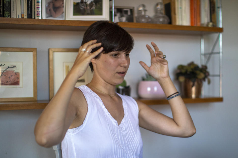 In this photo taken on Wednesday, June 19, 2019, Clara Massons speaks during an interview with The Associated Press at her home in Barcelona, Spain. Outdated medical practices related to childbirth that continue to be used despite evidence they cause harm have come under increasing scrutiny in Europe. (AP Photo/Emilio Morenatti)