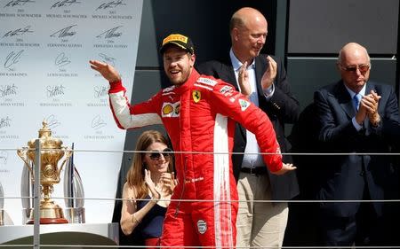 Formula One F1 - British Grand Prix - Silverstone Circuit, Silverstone, Britain - July 8, 2018 Ferrari's Sebastian Vettel celebrates winning the race on the podium with the trophy REUTERS/Andrew Yates