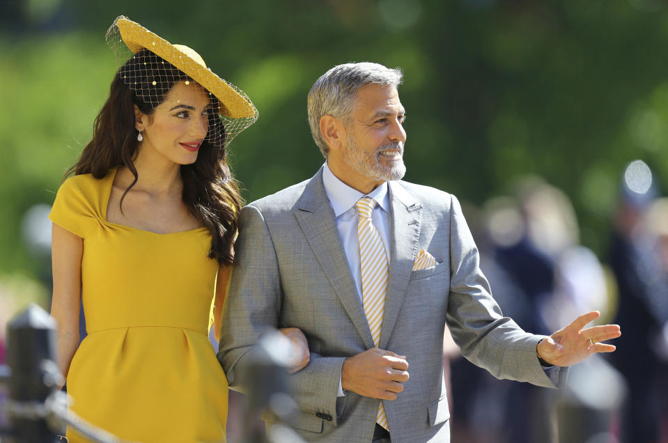 Amal Clooney and George Clooney wave to the crowd. Source: AP