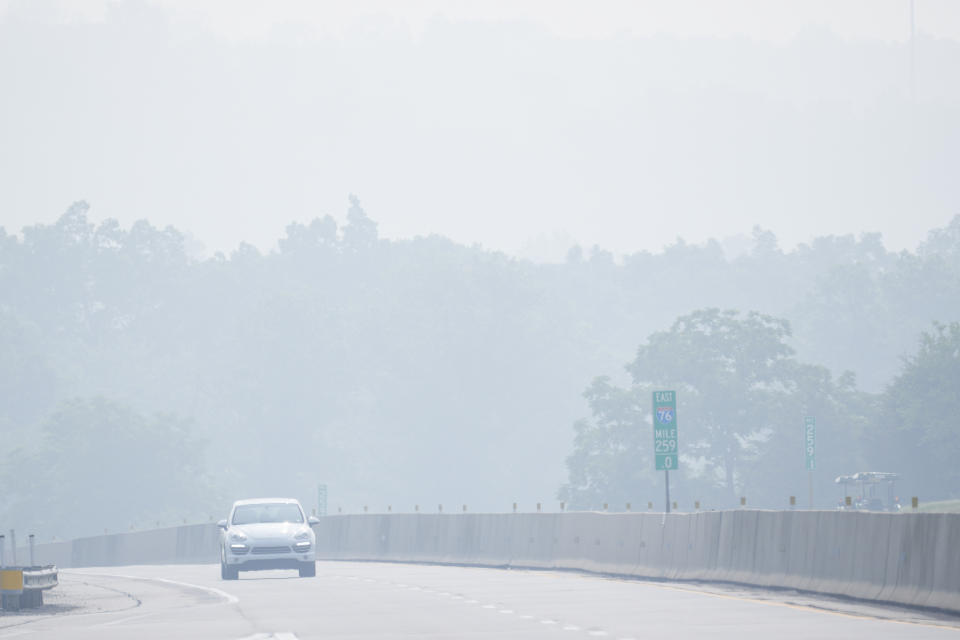 A vehicle drives through a haze from Canadian wildfires on Interstate 76 near Hershey, Pa., Thursday, June 29, 2023. (AP Photo/Matt Rourke)