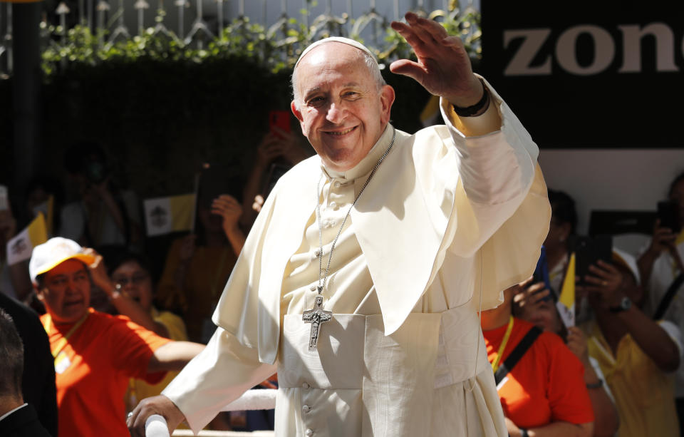 Pope Francis waves to a crowd standing hours to greet him as he arrives at the Saint Louis Hospital in Bangkok, Thailand, Thursday, Nov. 21, 2019. Pope Francis called for migrants to be welcomed and for women and children to be protected from exploitation, abuse and enslavement as he began a busy two days of activities in Thailand on Thursday. (AP Photo/Manish Swarup)